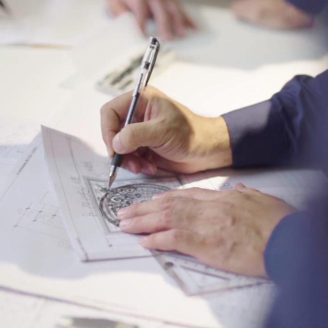 About Kingston Professional designer sketching details for Custom Pivot Doors at our design studio.