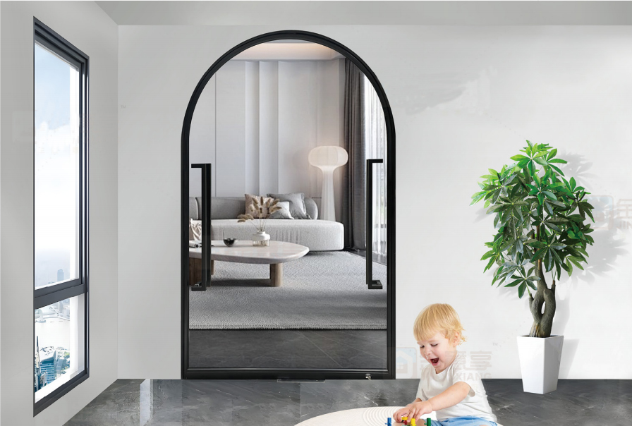 Arched black frame pivot door separating the playroom from the living room.