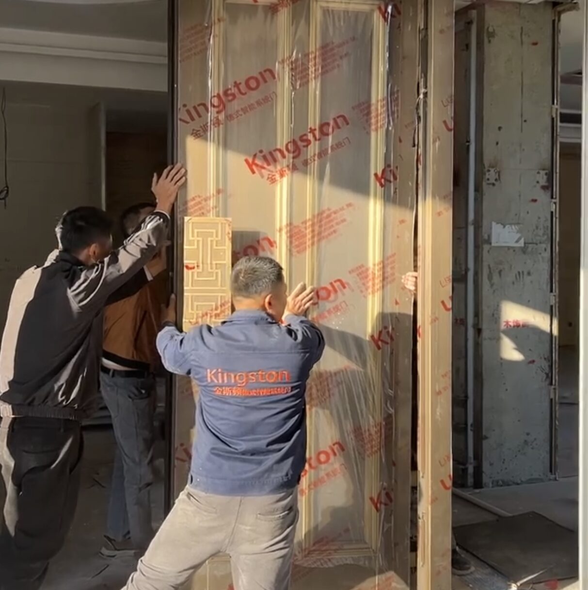 About Kingston Kingston professional team installing a large custom pivot door at a construction site.
