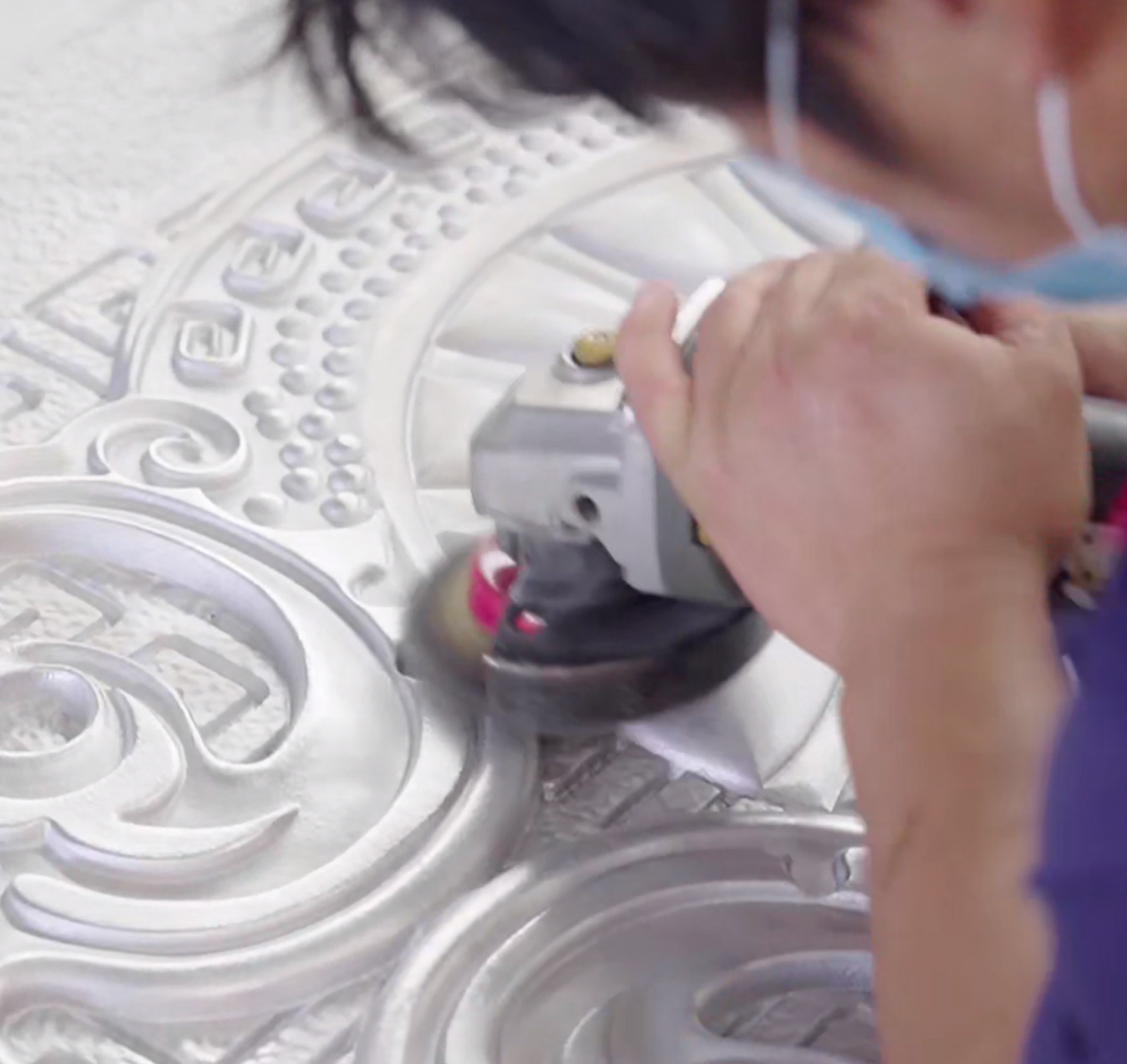 About Kingston Close-up of a skilled factory artisan hand-polishing intricate patterns on a cast aluminum door panel.