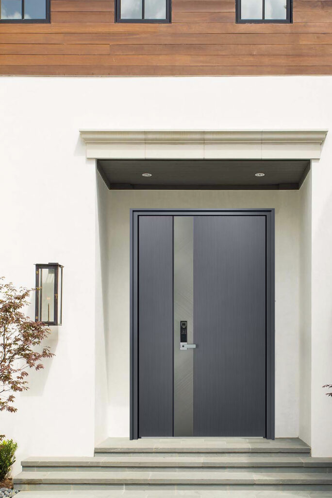 Technical Analysis: Large-span Patio Systems Engineering and Performance Oversized grey pivot front door with a central vertical brushed metal accent strip.