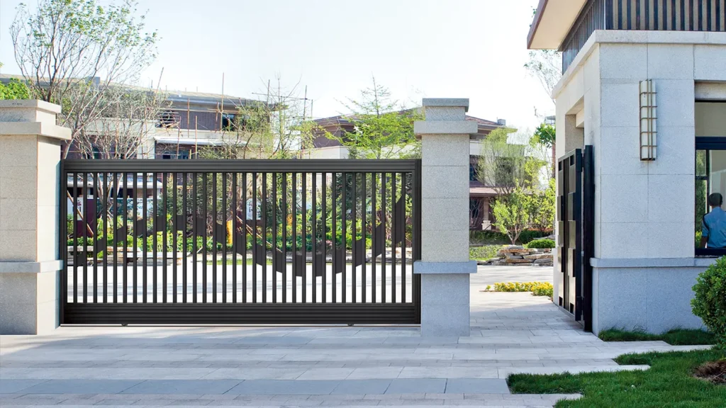 Modern aluminum sliding gate installed at a residential courtyard entrance, featuring minimalist vertical slats and durable outdoor design.