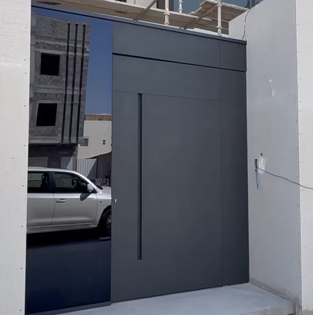 Contemporary Grey Pivot Door featuring a sleek integrated glass panel and minimalist recessed handle.